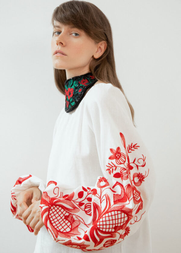Blouse based on the motifs of a traditional shirt with designer embroidery