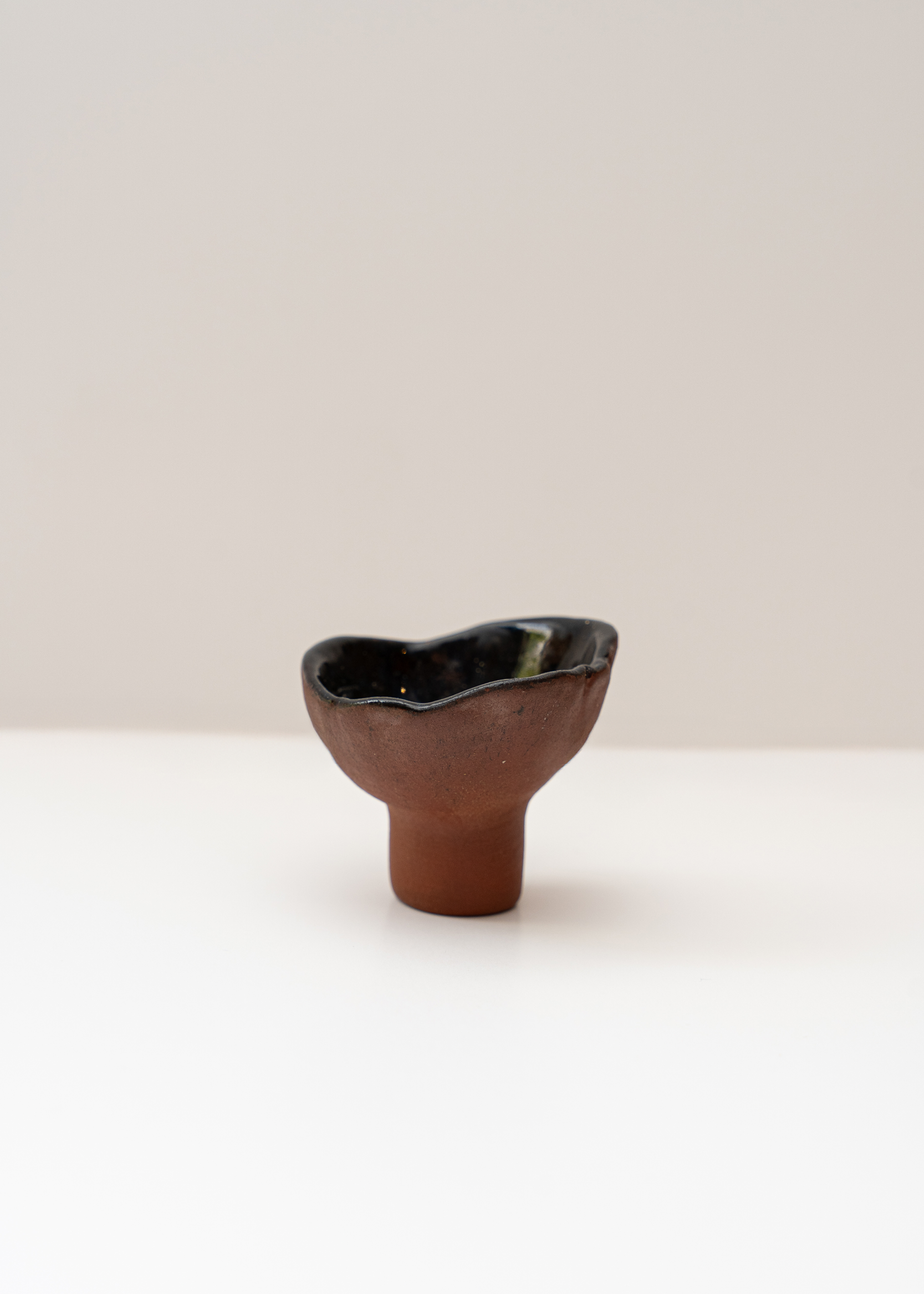 Asymmetric ceramic candle holder