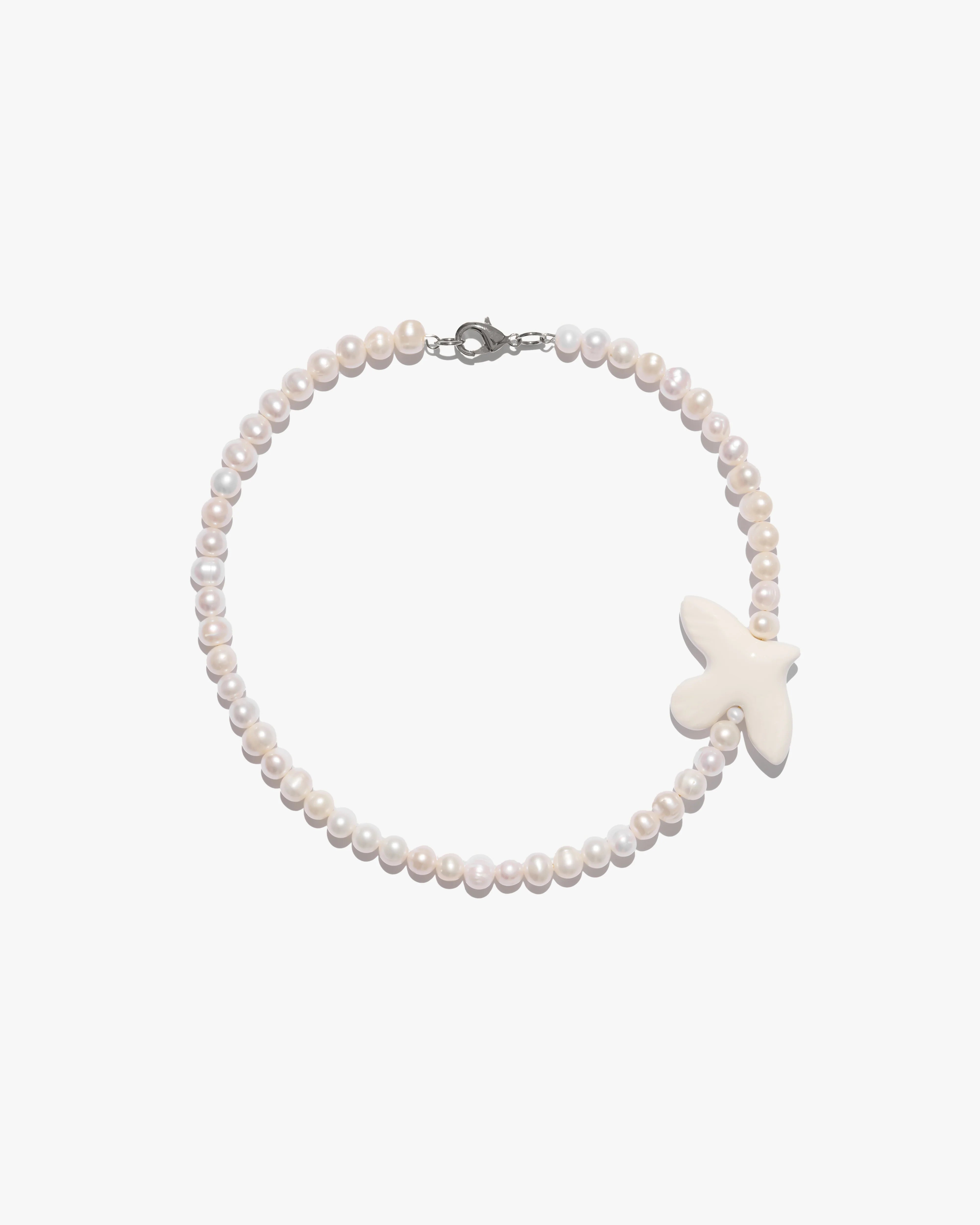 Necklace "Myrni" with medium pearls and a bird