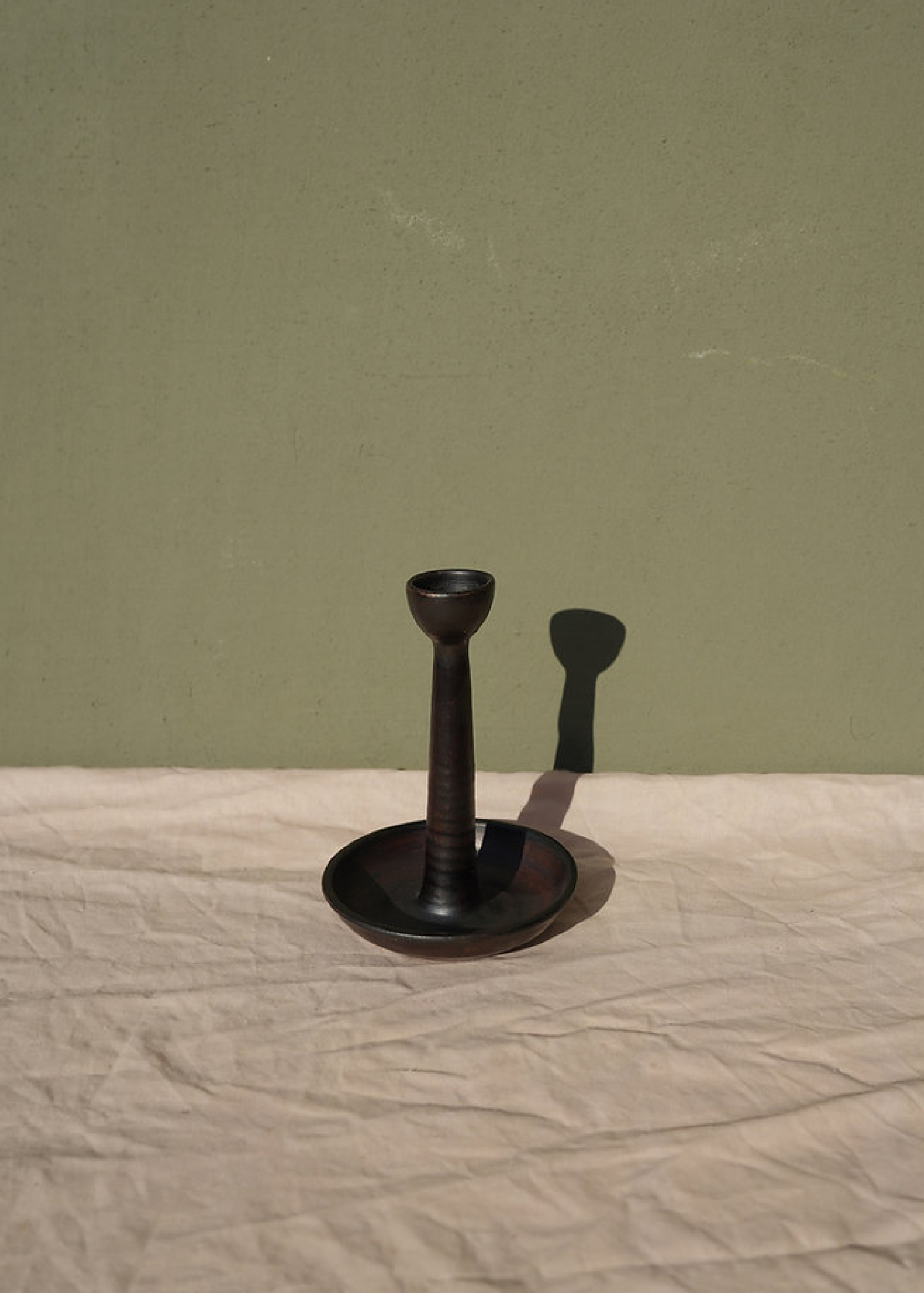 Tall candle holder for a single candle