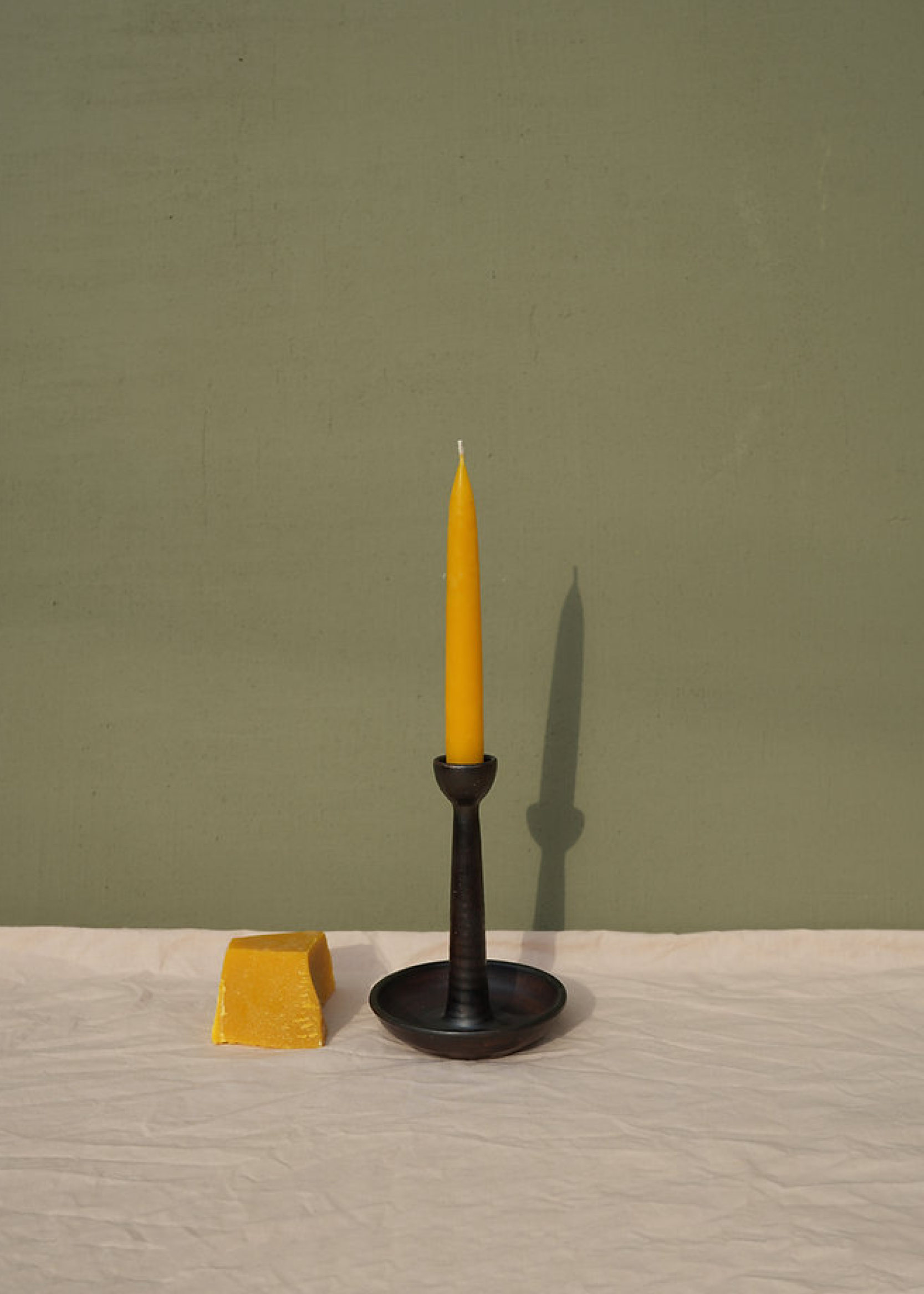 Tall candle holder for a single candle