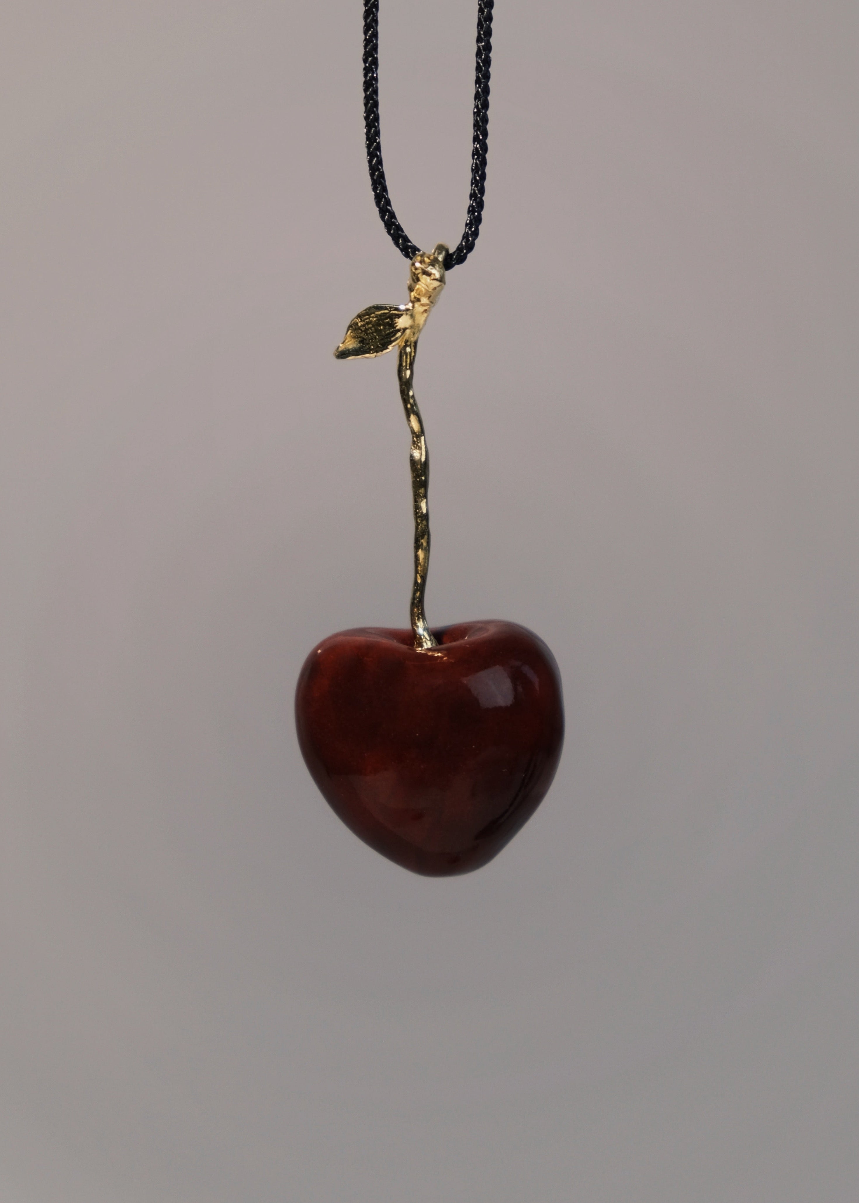 "Cherry" pendant on a cord (brass)