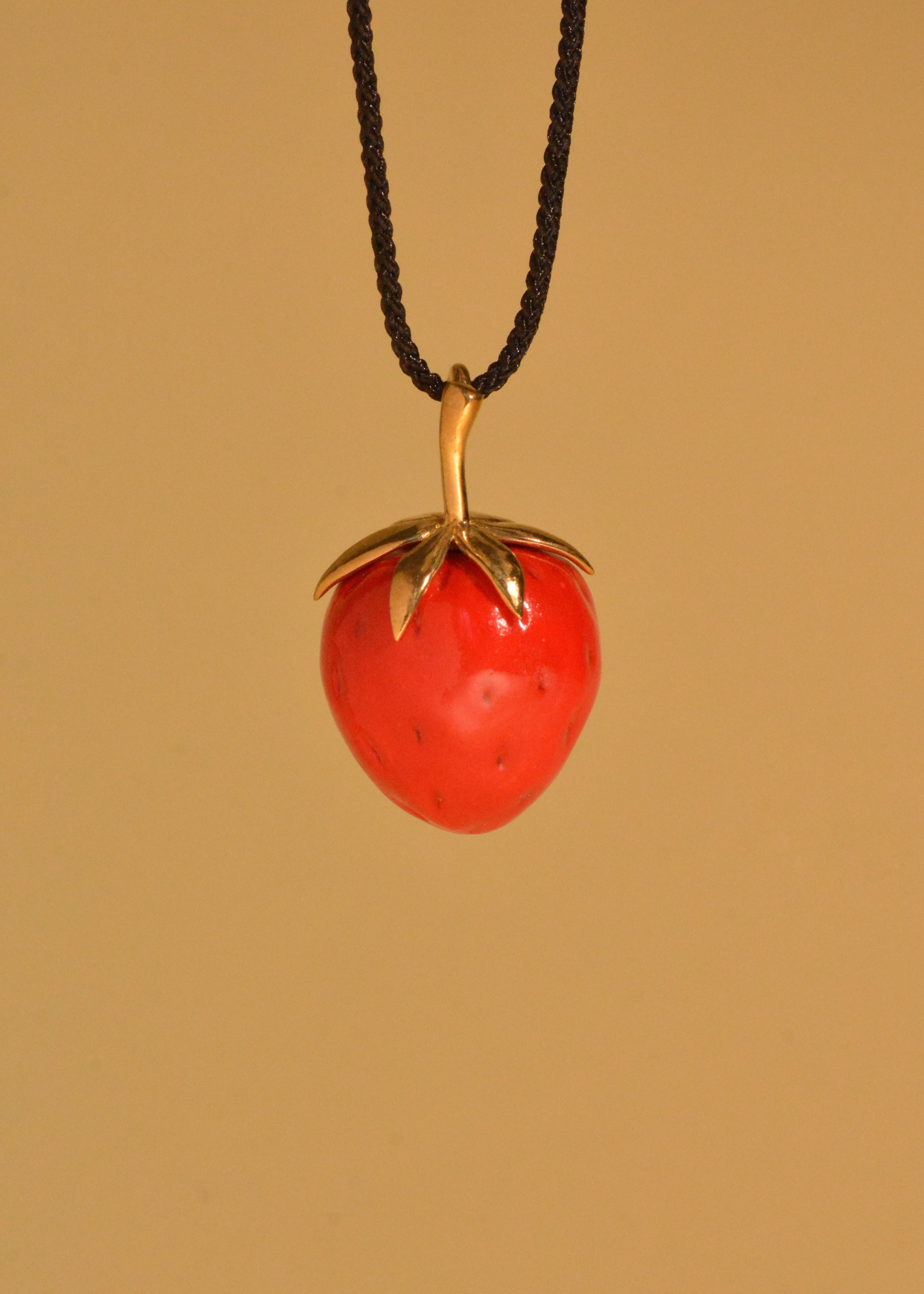 "Strawberry" pendant on a cord (brass)