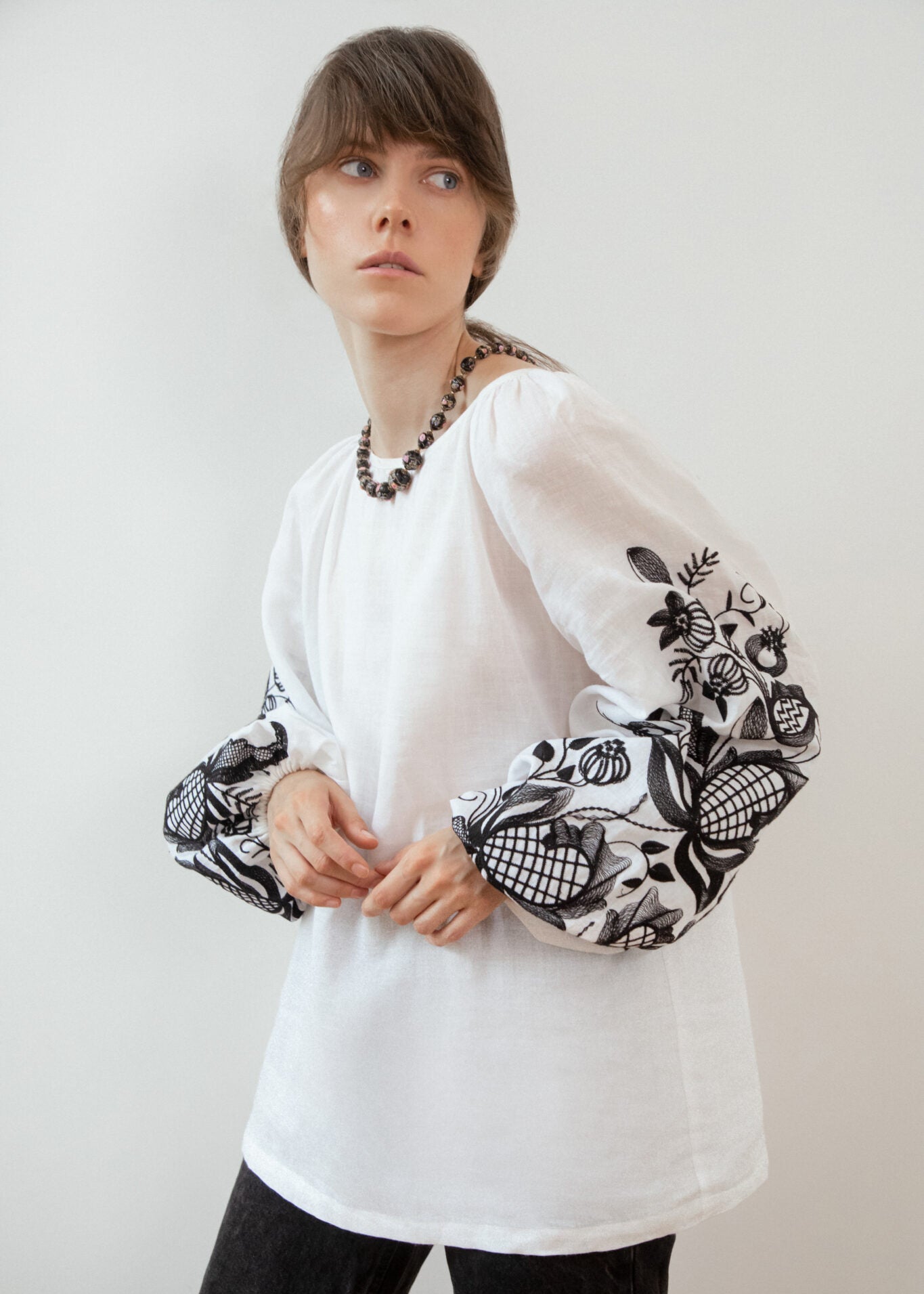 Blouse based on the motifs of a traditional shirt with designer embroidery (black ornament)