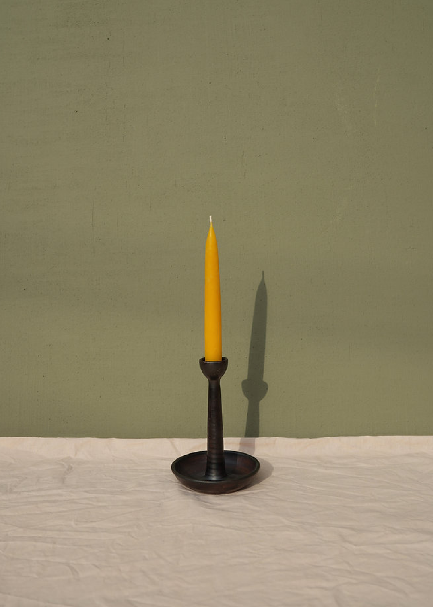 Tall candle holder for a single candle