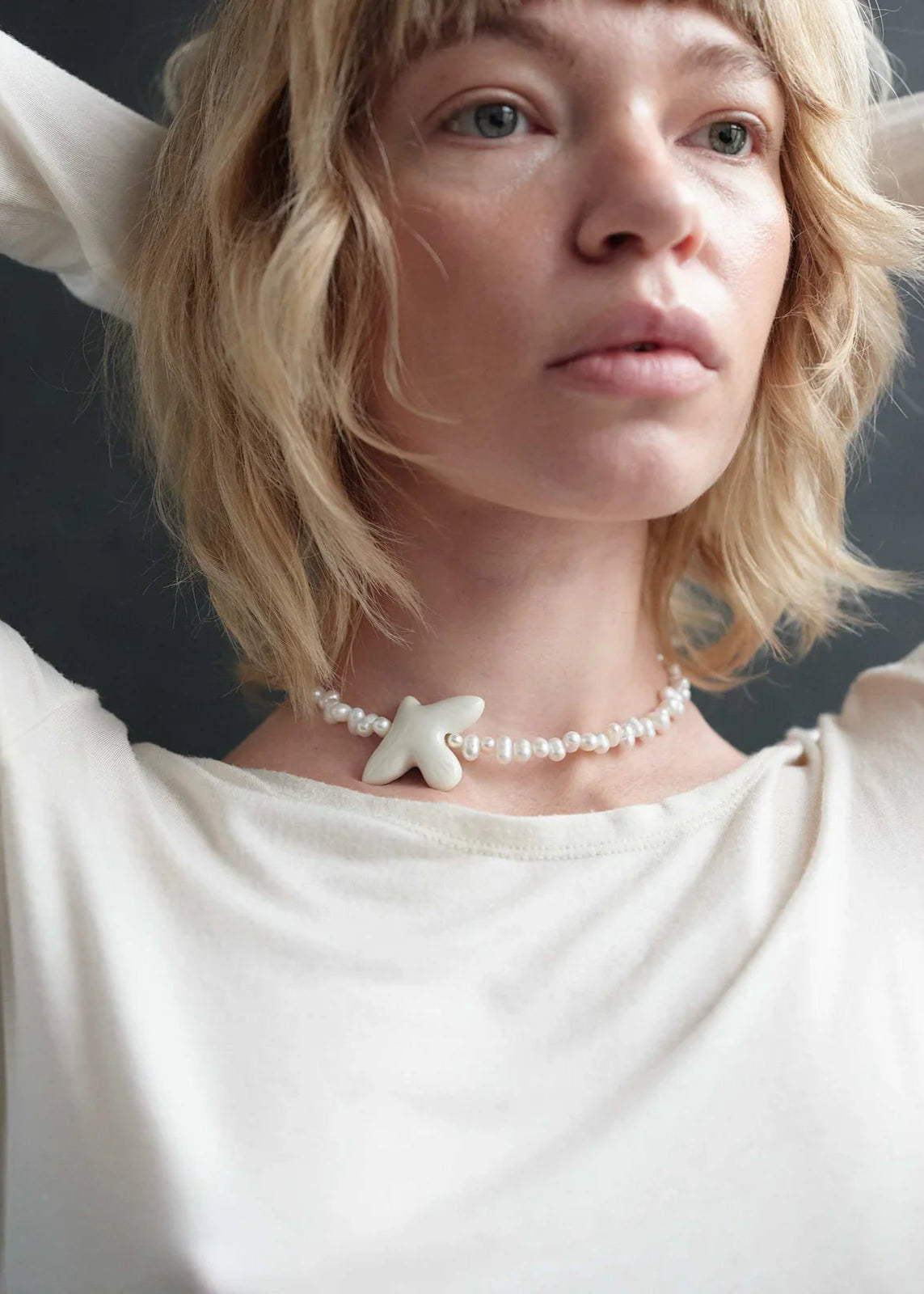 Necklace "Myrni" with uneven pearls and a dove